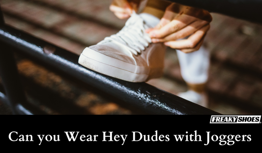 Freaky Shoes® custom art sneakers with skull design, made to order, worn with joggers on urban bench