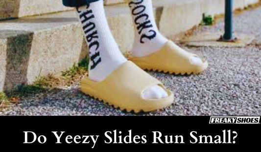 Freaky Shoes custom art sneakers: beige Yeezy-style slides with bold sock lettering, made to order wearable art.