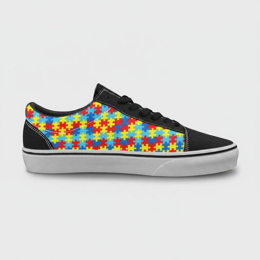 Freaky Shoes® men's low-top canvas skateboarding sneakers featuring a colorful autism awareness puzzle piece pattern.