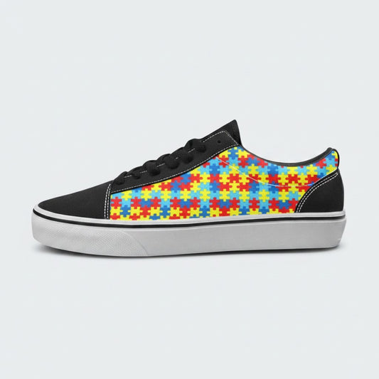 Freaky Shoes® women's low-top canvas skateboarding shoes featuring a colorful autism awareness puzzle piece pattern.