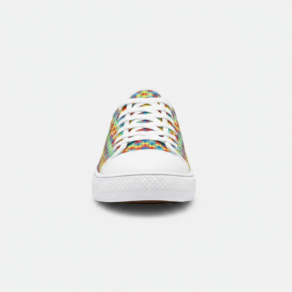 Freaky Shoes® low-top canvas sneakers featuring a colorful autism awareness puzzle piece print and white rubber toe.