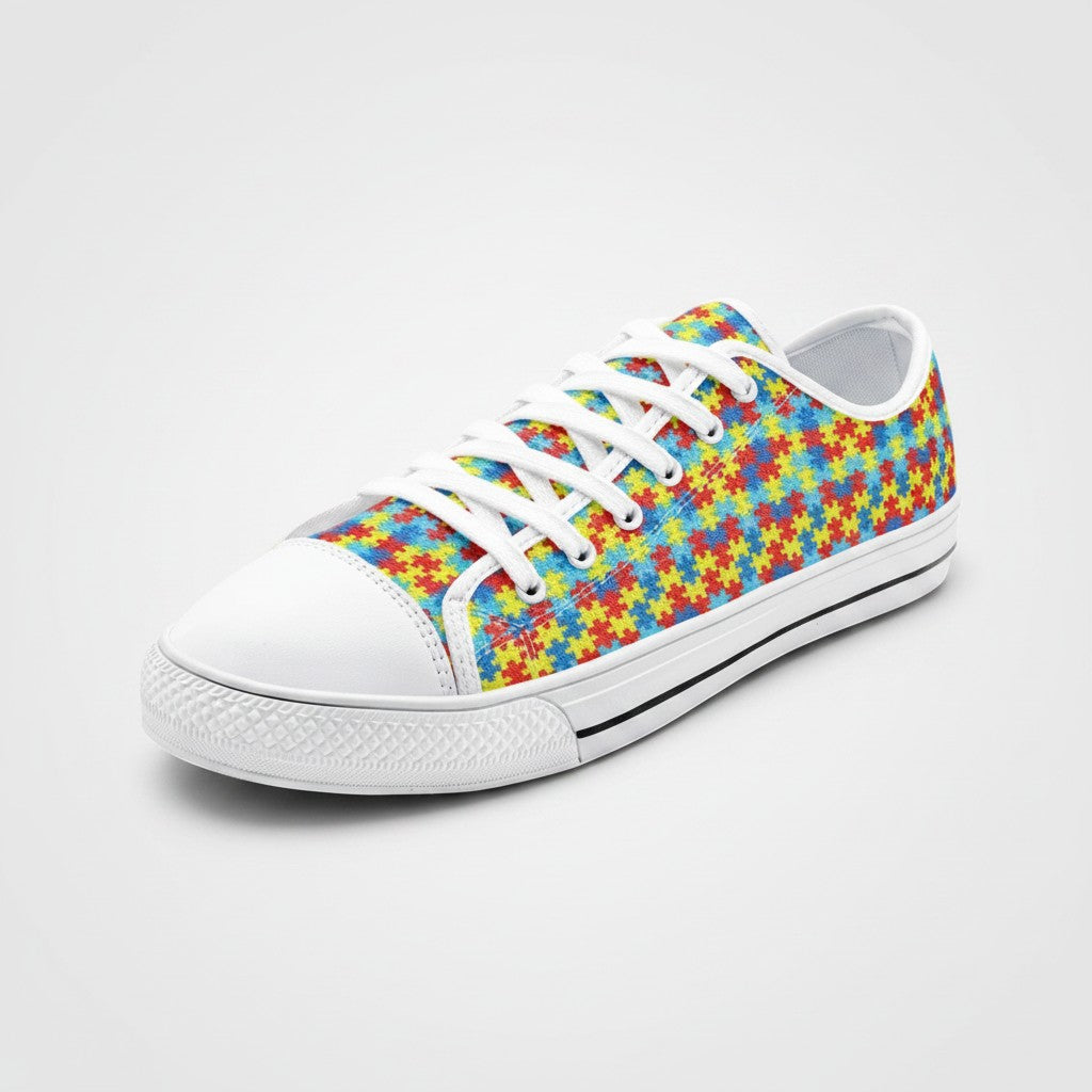 Freaky Shoes® low-top canvas sneakers featuring a colorful autism awareness puzzle piece print and white laces.