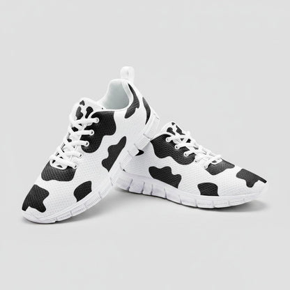 Freaky Shoes® high-top canvas sneakers featuring a black and white cow print pattern with white laces and EVA soles.