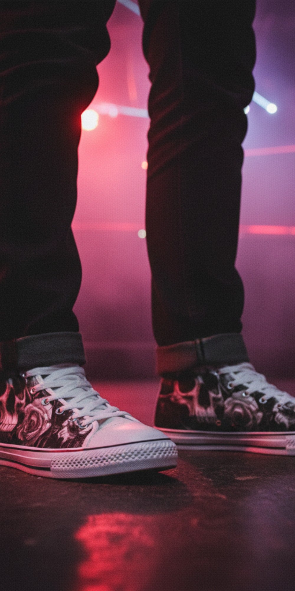 Freaky Shoes® gothic skull and rose print canvas high top sneakers worn with dark jeans in a neon-lit club setting.
