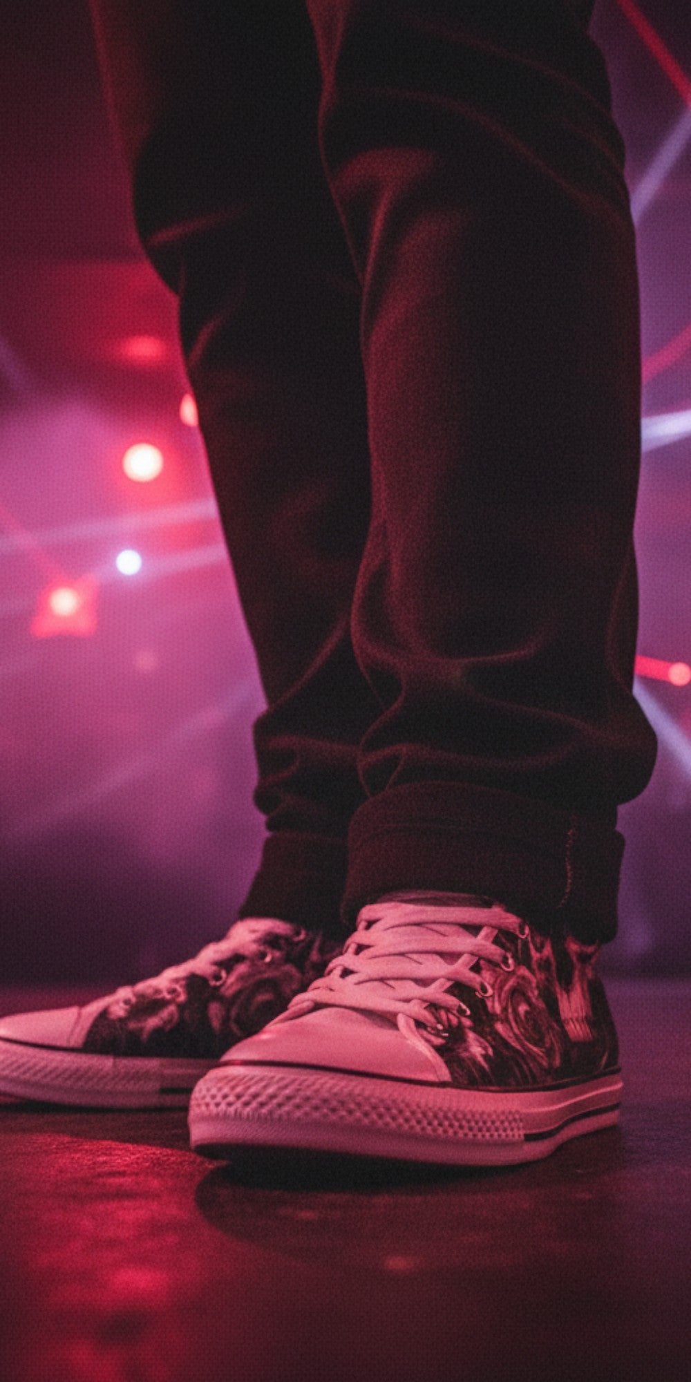 Freaky Shoes® gothic high top canvas sneakers with skull and rose print worn in a dark club with red laser lighting.
