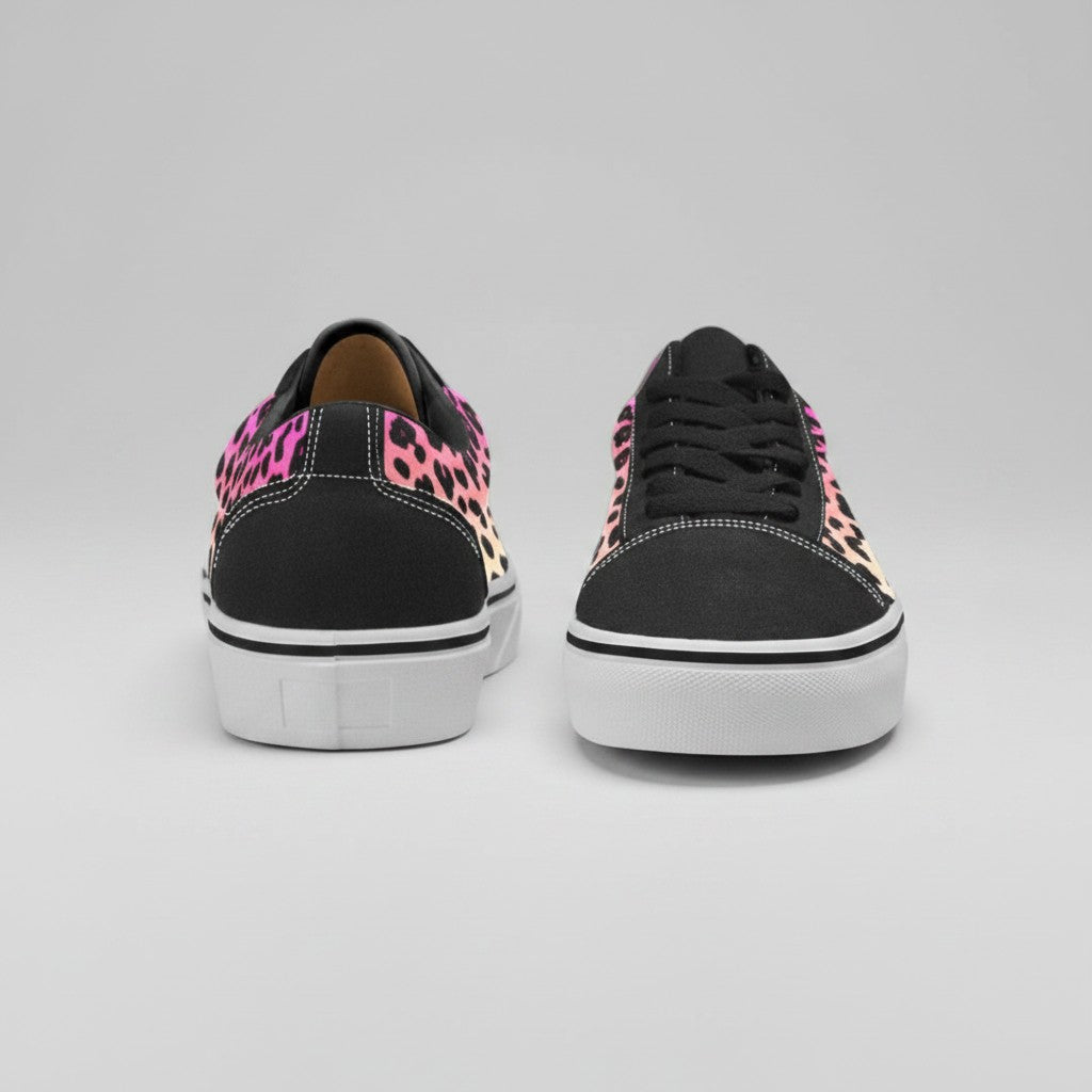 Freaky Shoes® women's low-top canvas skateboarding shoes featuring a vibrant pink and orange gradient leopard print.