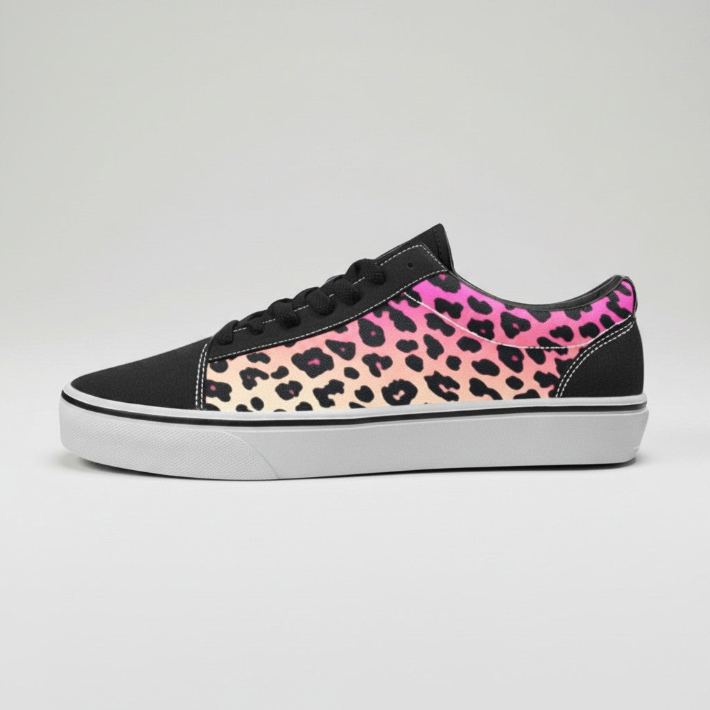 Freaky Shoes® women's low-top canvas skateboarding sneakers featuring a vibrant pink and orange gradient leopard print.