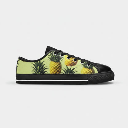 Freaky Shoes® women's low-top canvas sneakers featuring a vibrant yellow pineapple print on a light green background.