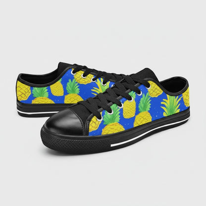 Freaky Shoes® women's canvas sneakers featuring a vibrant blue background with a yellow pineapple pattern and black trim.