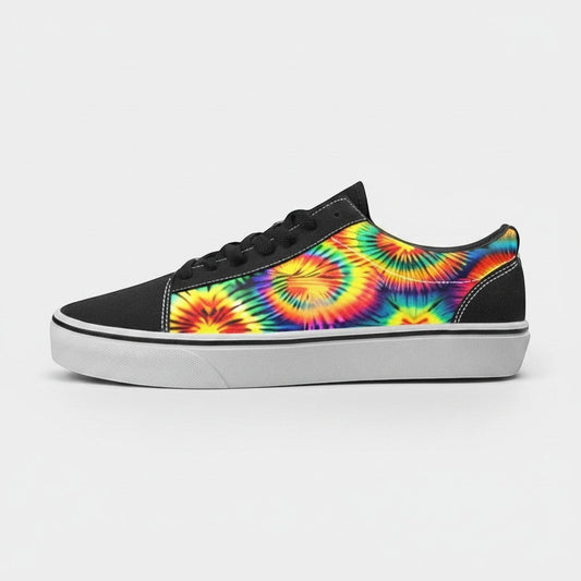 Freaky Shoes® women's low-top canvas skateboarding sneakers featuring a vibrant rainbow tie-dye pattern and black trim.