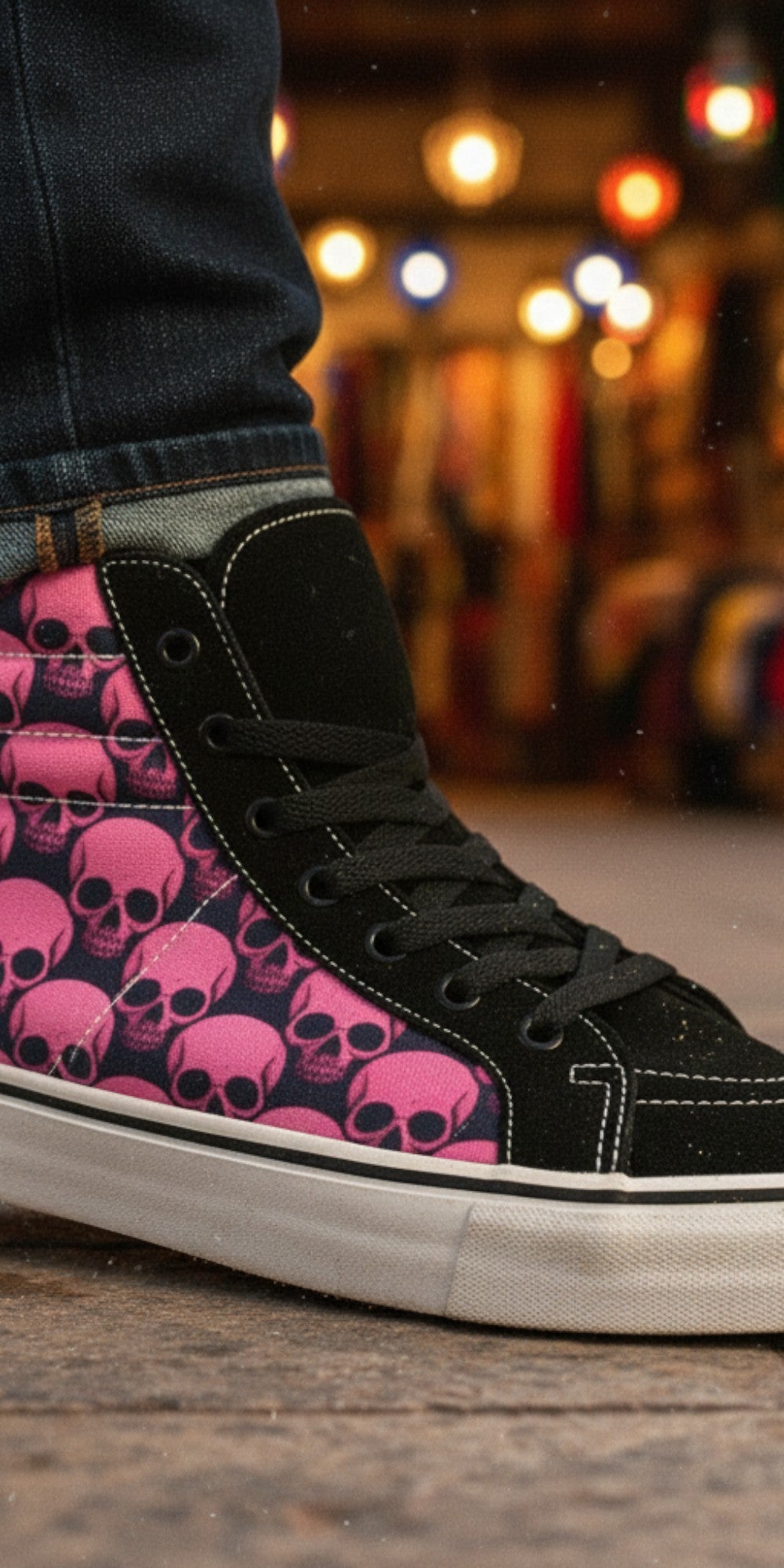 Freaky Shoes® women's high top skate sneakers featuring a pink and black skull comix print on a black canvas base.