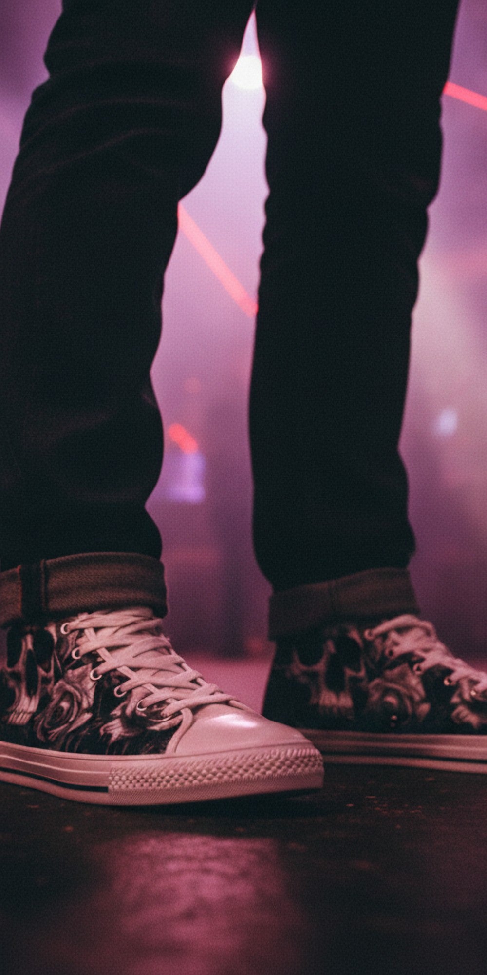 Person wearing Freaky Shoes® Skull & Rose gothic high top canvas sneakers in a dark, red-lit club setting.