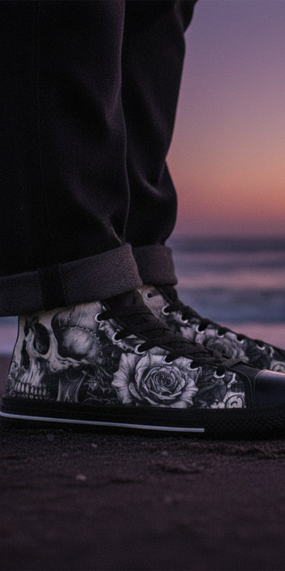 Freaky Shoes® high top canvas sneakers with black and white skull and rose art, worn on a beach at sunset.