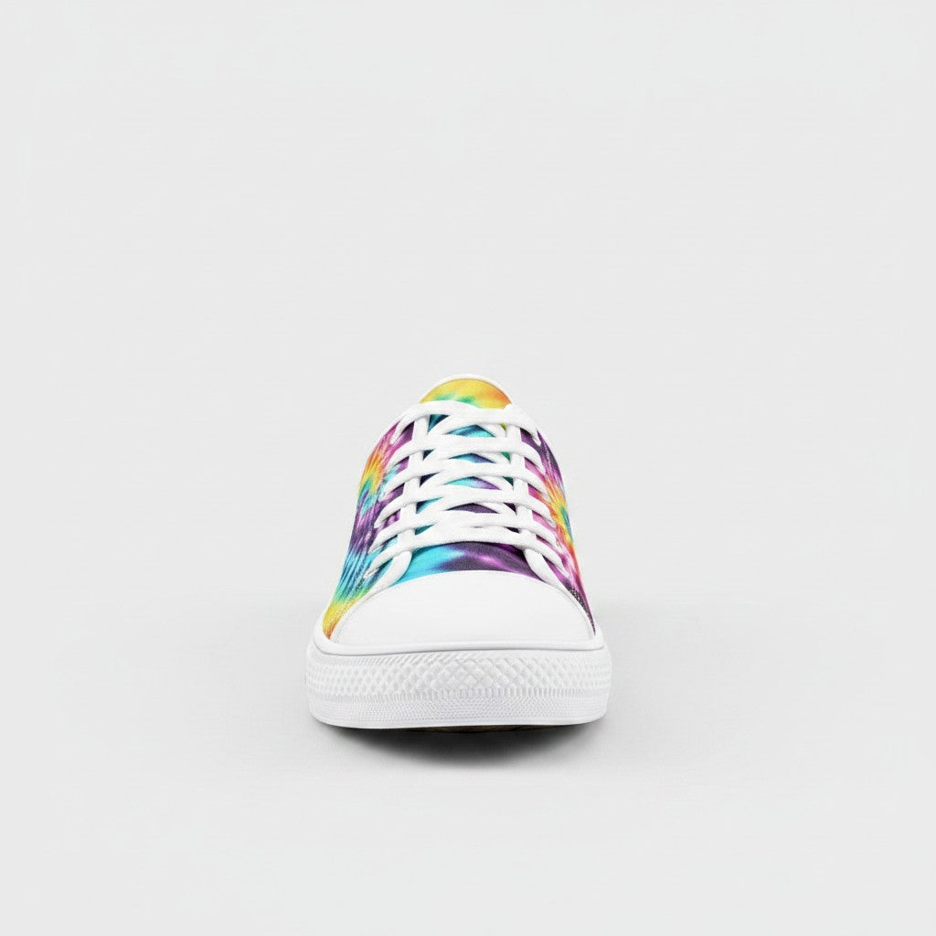Freaky Shoes® low-top canvas sneakers featuring a vibrant multi-color tie-dye pattern and white rubber toe cap.
