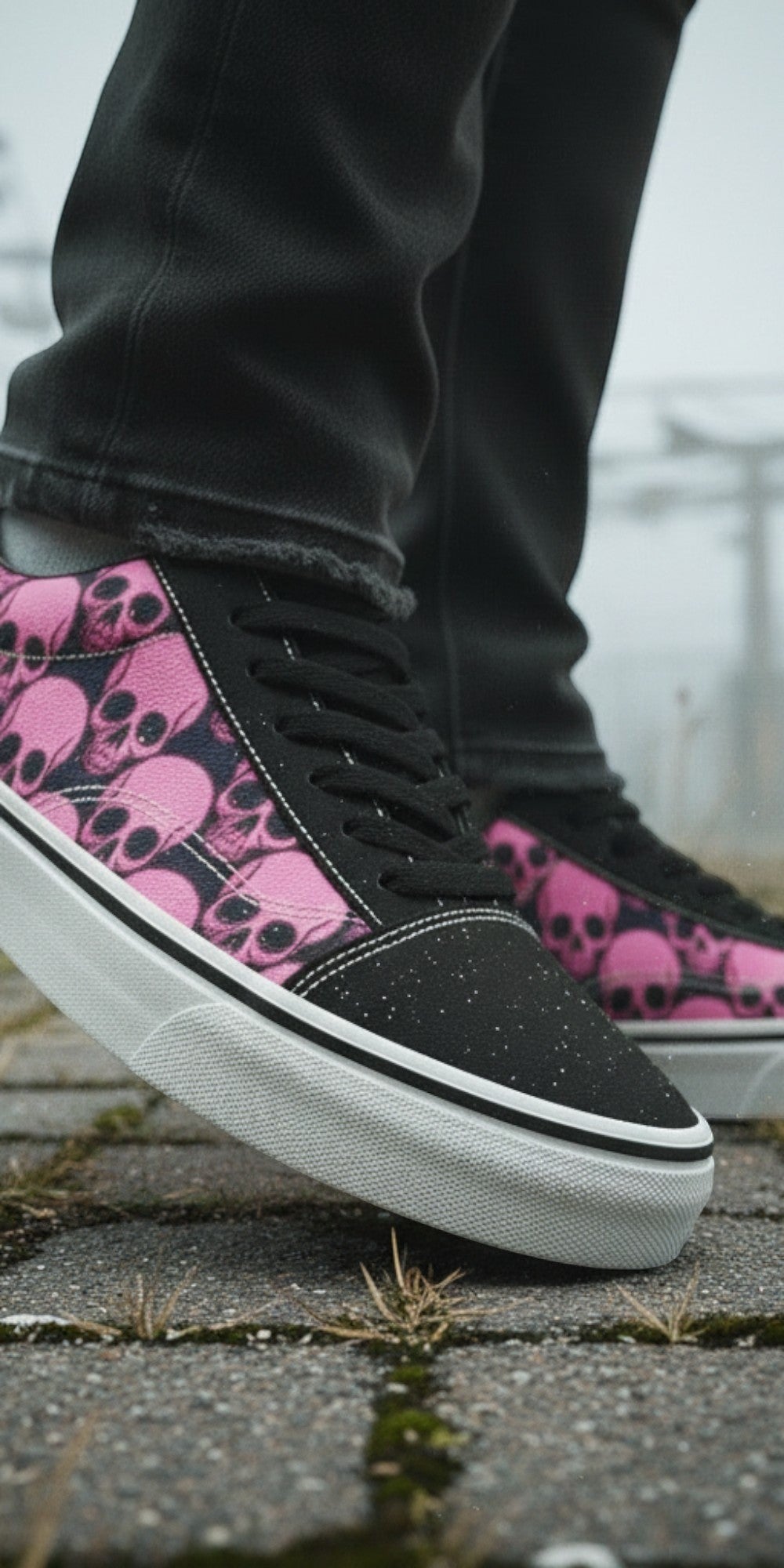 Freaky Shoes® women's low top skate sneakers featuring a black and pink skull comic print on a paved outdoor path.